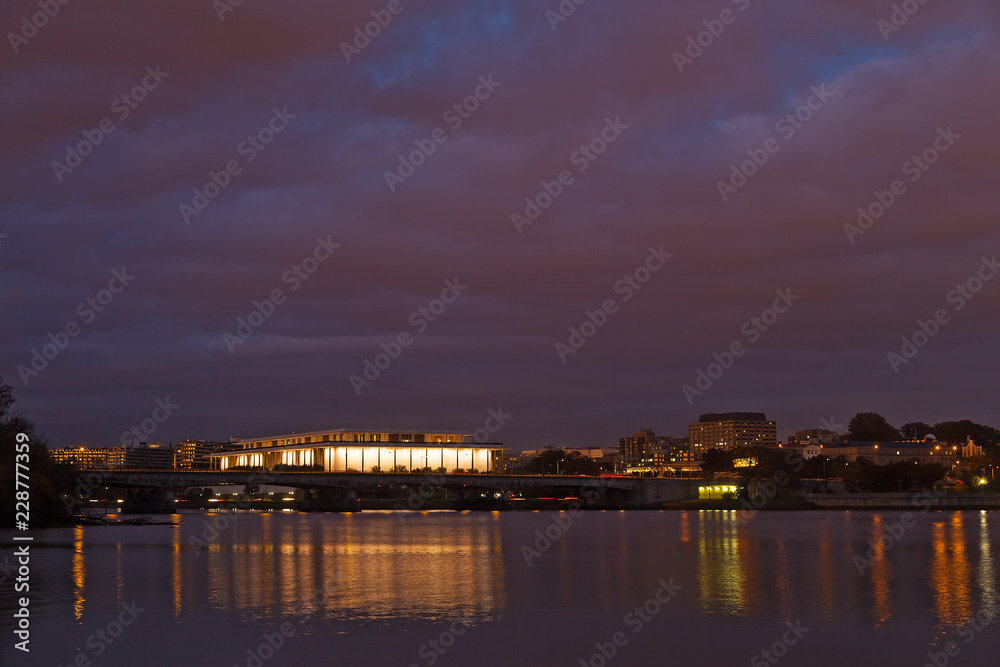 Washington DC panorama photographed from Arlington Memorial Bridge, USA. Night city skyline with reflection in quiet waters of Potomac River.