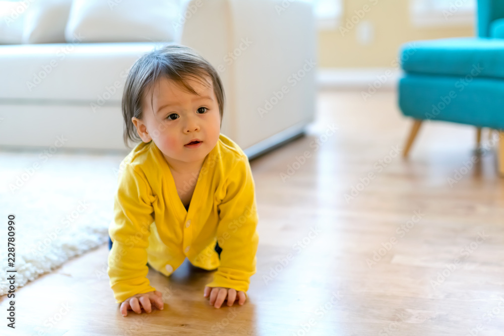 Toddler boy in yellow clothes playing in his house Toddler boy in yellow clothes playing in his house