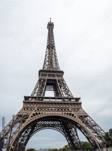 Front VIew of the Eiffel Tower From the Street with Cloudy Skies