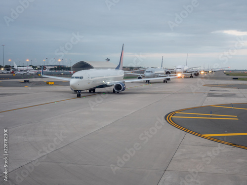 Multiple Airplanes Awaiting to Take off on Early Morning