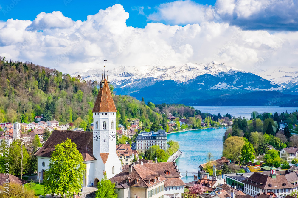 Aerial Scenery of Old Town Cityscape from Thun Castle and Alpine Mountain Range in Switzerland with Cloudy. Swiss Village among Swiss Alps. Scenic Landscape of Switzerland Country with Snowy Mountain.