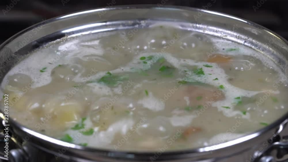 Vegetable boiling soup with mushrooms and potatoes. Healthy food, mushrooms soup in pan, close up Vegetable boiling soup with mushrooms and potatoes. Healthy food, mushrooms soup in pan, close up