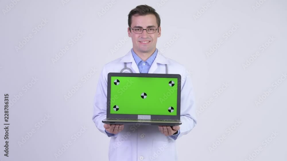 Young happy handsome man doctor showing laptop Young happy handsome man doctor showing laptop