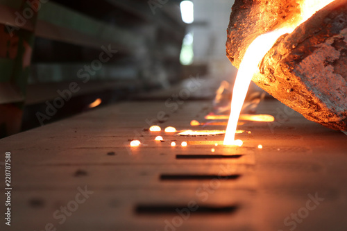 Casting iron by green sand process ; technology for Casting, in the metal industry, the process that molten metal is poured  into a mold , where it solidifies into shape , Industrial background