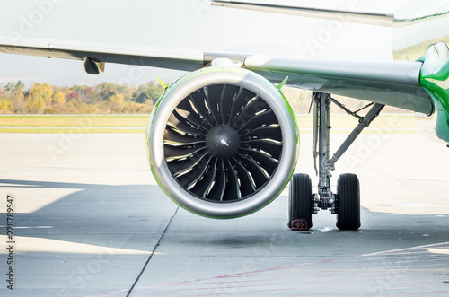 Turbine of aircraft's engine under wing. Plane on runway. Service and maintenance of airplanes. Aviation and transportation.