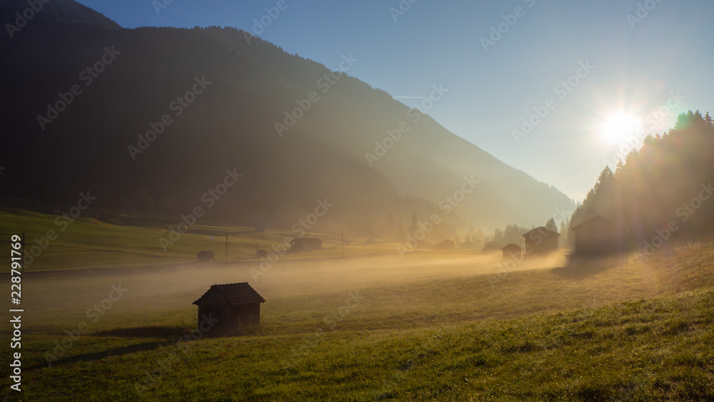 Fototapeta premium Fall sunrise on the alps with moisture in the air