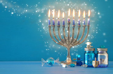 image of jewish holiday Hanukkah background with menorah (traditional candelabra) and candles.