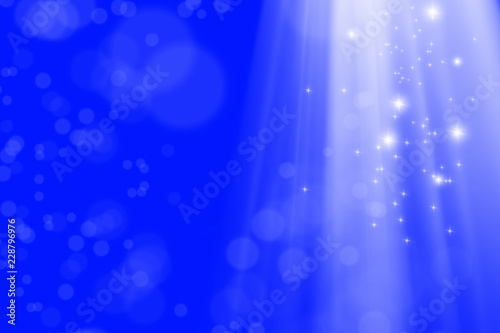 abstract background image of blurry lights and light beam manipulations over blue background