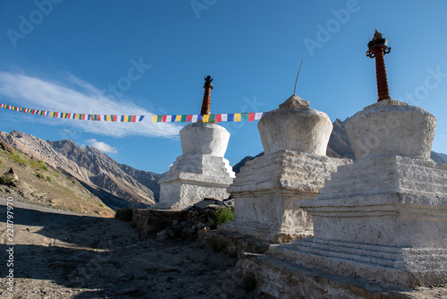 Beautiful landscape in Rangdum with ancient white Buddhist stupa (chorten) at Himalaya Range, Zanskar Range, Pensi La, Jammu and Kashmir, India. photo