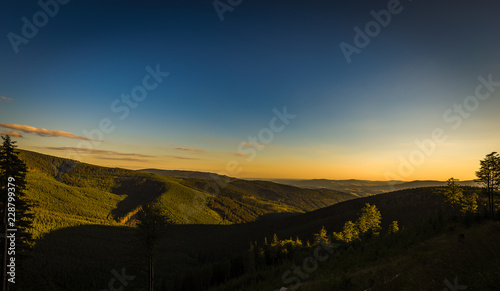 Yellow sunset and dark blue sky on path from Serak to Ramzova, scenic view on valleys in Jeseniky, Czech Republic