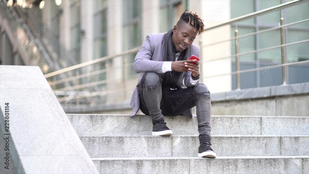 Portrait of Afro-American man using the mobile phone in the city Portrait of Afro-American man using the mobile phone in the city