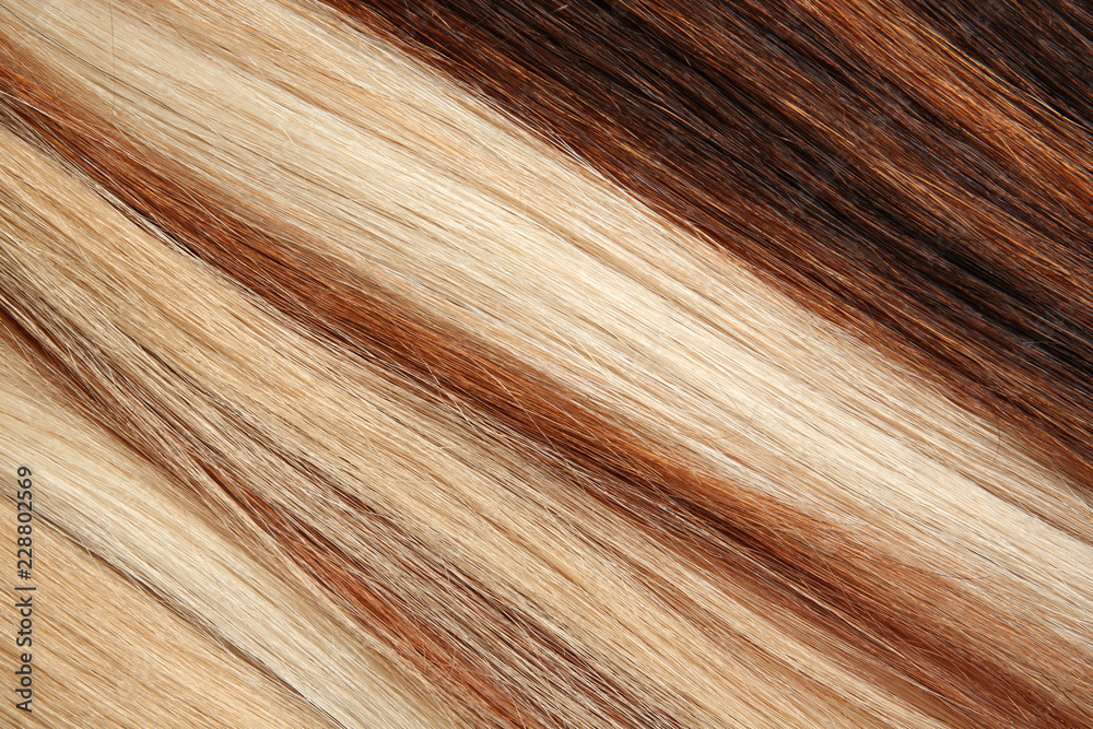 Naklejka premium Strands of different color hair as background, closeup