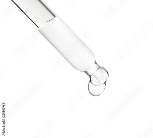 Pipette with essential oil on white background photo