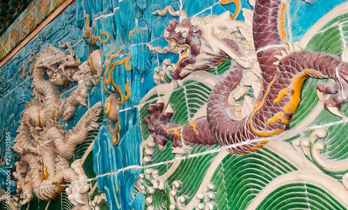 Dragon sculpture. The Nine-Dragon Wall (Jiulongbi) at Beihai park, Beijing, China. The wall was built in 1756 CE photo