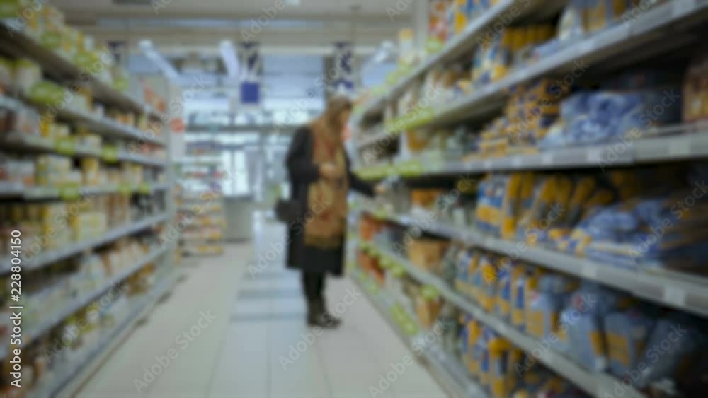 Defocus girl choosing pasta in the supermarket in Italy