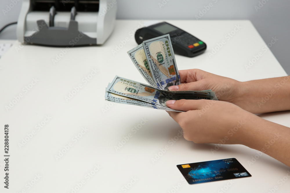 Woman with money and credit card at table, closeup Woman with money and credit card at table, closeup