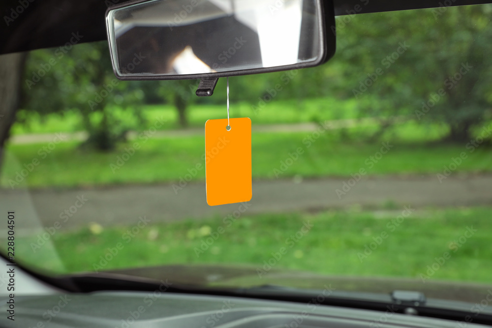 Fototapeta premium Air freshener hanging in car against windshield
