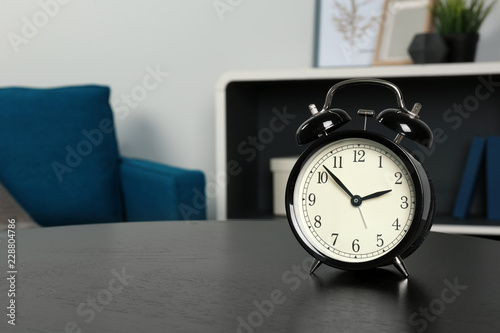 Alarm clock on table indoors, space for text. Time management