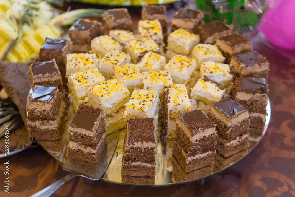 cut cake in a restaurant,On a buffet table cut pieces of cake cut cake in a restaurant,On a buffet table cut pieces of cake