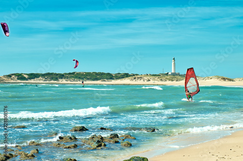 Photography People surfing in front of the lighthouse of Trafalgar, on the beach of Los Caño