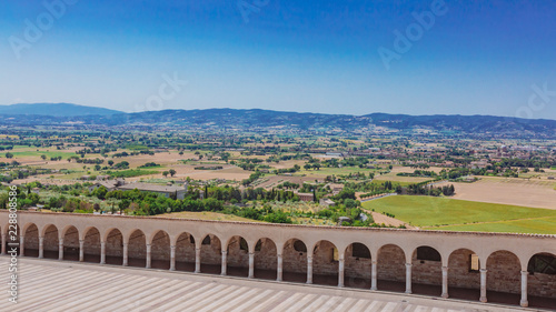 Corridor of lower square of St Francis in Assisi, Italy, with landscape in the distance