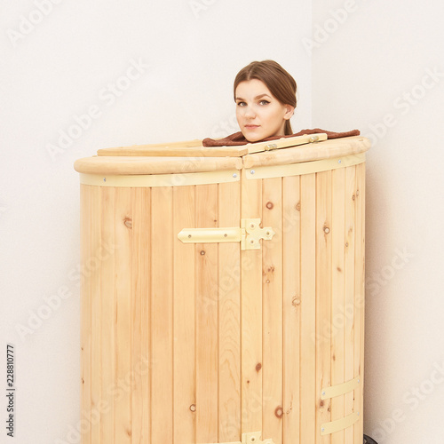 Barrel cedar. Wellness spa sauna. Aromatherapy treatment. Young beauty woman. Girl face photo