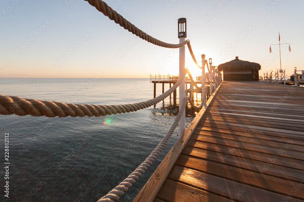 Obraz premium wooden pier sun-drenched, sunset or dawn