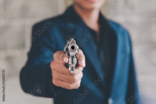 Businessman holding a gun to kill himself committed suicide because of despondent and despair in the office.