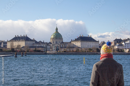 The dome of Frederik's Church (Frederiks Kirke), popularly known as the Marble Church (Marmorkirken), in Frederiksstaden district, Copenhagen, Denmark, with a warmly dressed tourist  in the foreground © Bede
