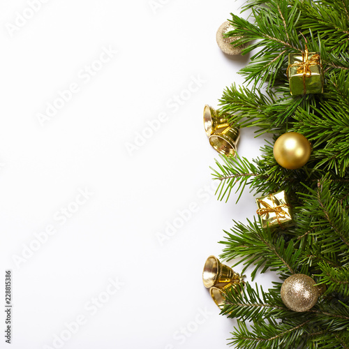 Fir tree branches and Christmas decorations on white background.