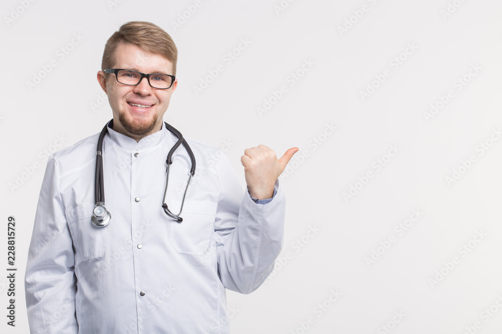 Male doctor pointing finger at copy space, isolated on white background. Medical concept. Male doctor pointing finger at copy space, isolated on white background. Medical concept.