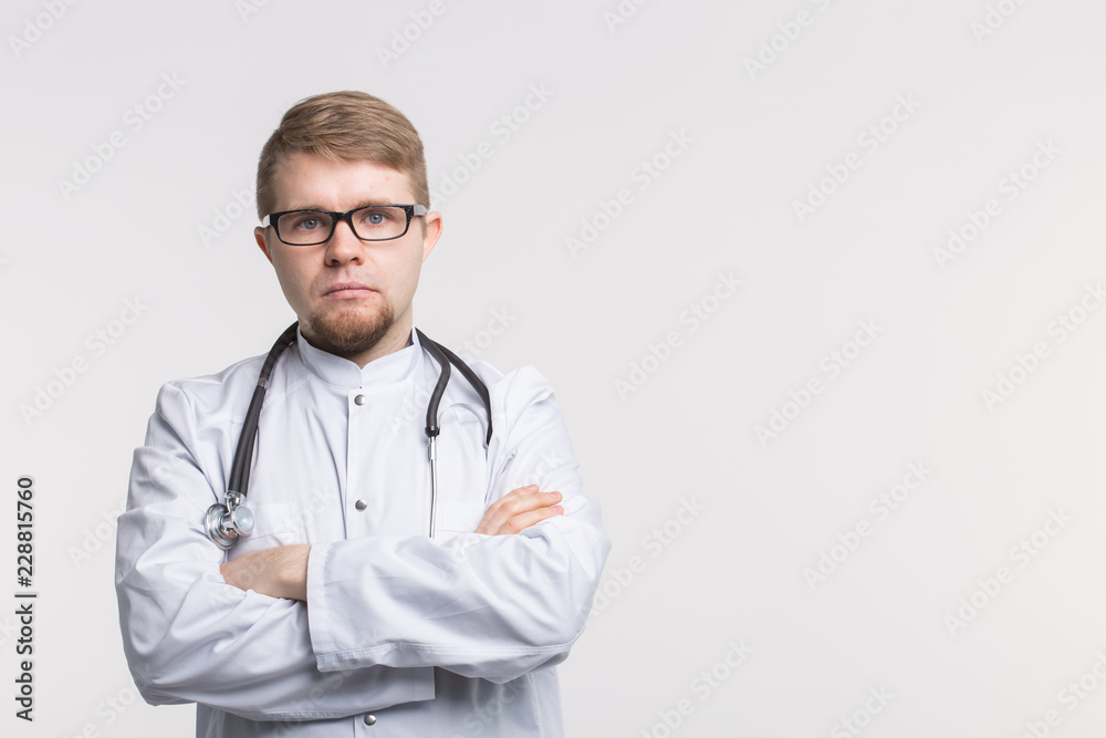 Male doctor standing on white background with copy space. Medical concept.