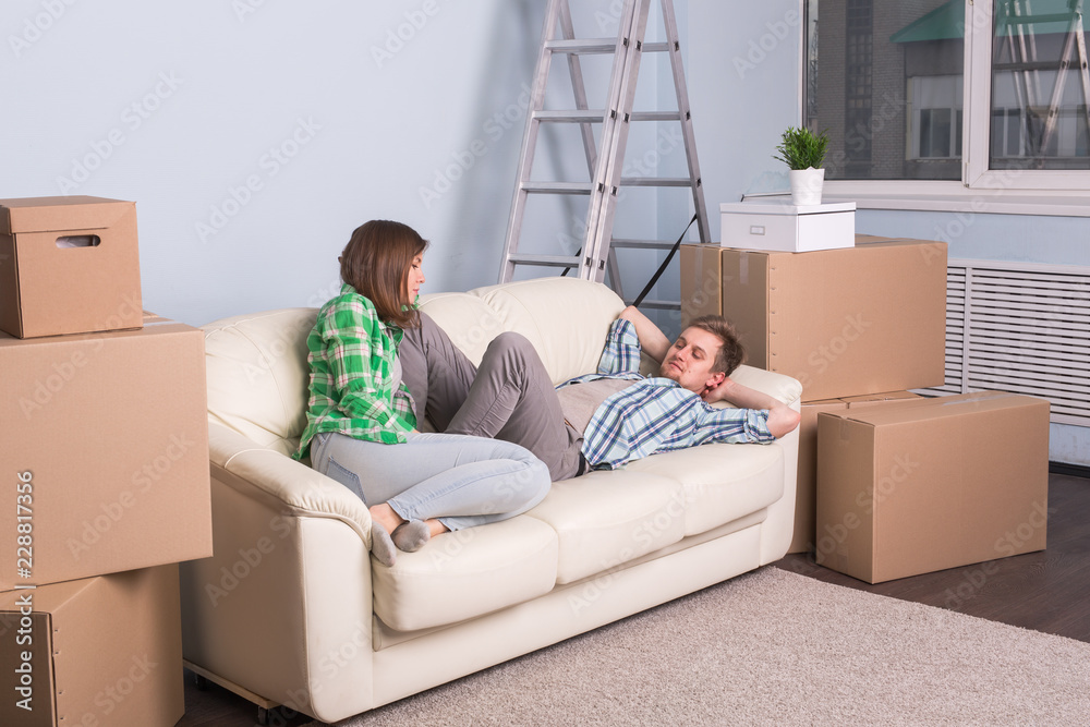 Relocation, real estate and moving concept - young couple people moved to a new apartment Relocation, real estate and moving concept - young couple people moved to a new apartment
