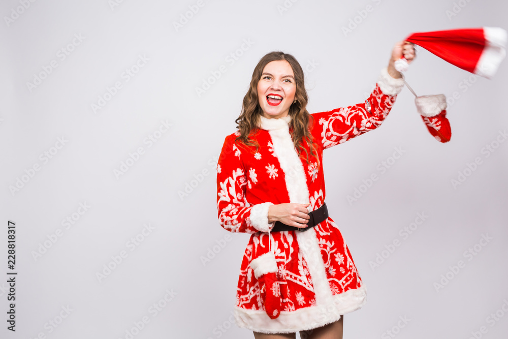 Christmas, people concept - woman in santa suit took off hat and having fun on white background Christmas, people concept - woman in santa suit took off hat and having fun on white background