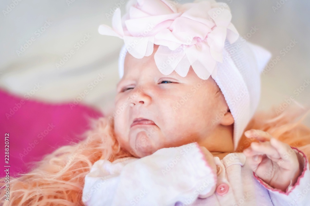 Cute newborn Caucasian baby about to start to cry, funny facial expression with bottom lip lower lip. Sad and upset infant child. Cute newborn Caucasian baby about to start to cry, funny facial expression with bottom lip lower lip. Sad and upset infant child.