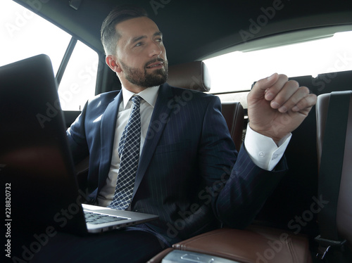 Confident businessman talking in car