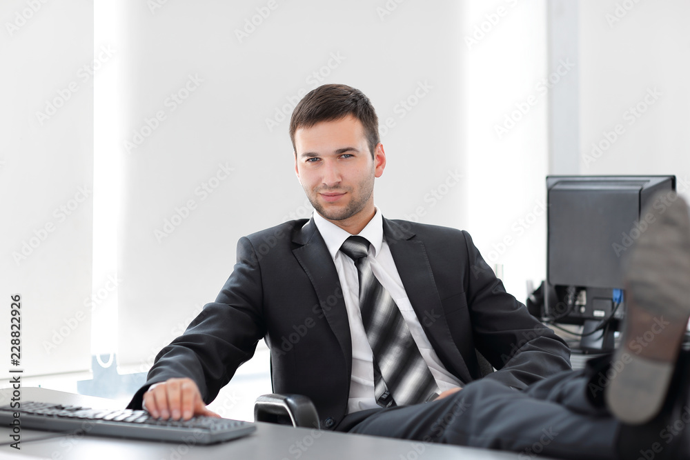 confident businessman sitting at Desk in a private office confident businessman sitting at Desk in a private office