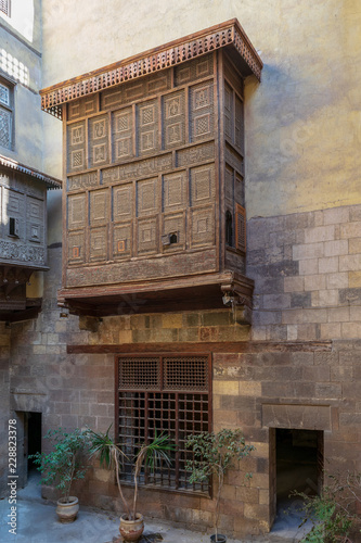 Facade of Zeinab Khatoun historic house with Mamluk era style oriel window covered by interleaved wooden grid (Mashrabiya), located near to Al-Azhar Mosque in Darb Al-Ahmar district, Old Cairo, Egypt photo