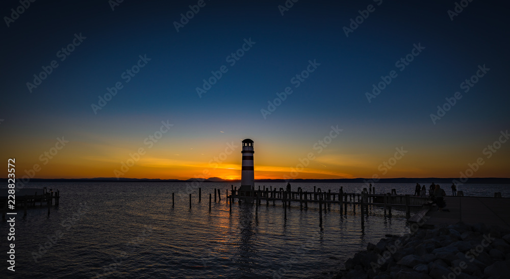 Beautiful colorful sunset over lake Neusiedler with Podersdorf lighthouse, Austria