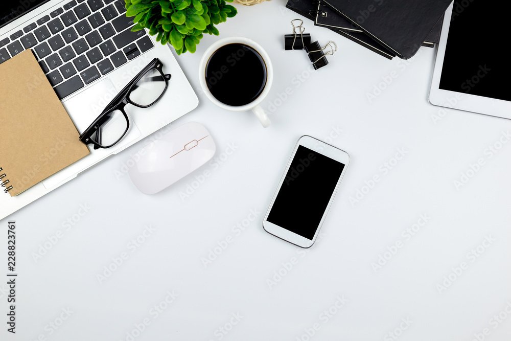 Workspace in office with tablet and smartphone with empty blank screens are on top,Top view with copy space.