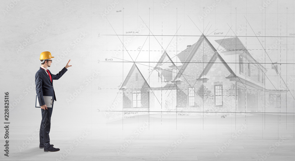 Architect standing and watching an imagined house plan
