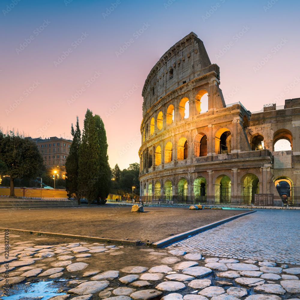 Roman Colosseum (Coliseum) in Rome in morning before sunrise, Rome, Italy. 