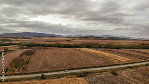 Aerial view of countryside in autumn with yellow fields and clouds in the background