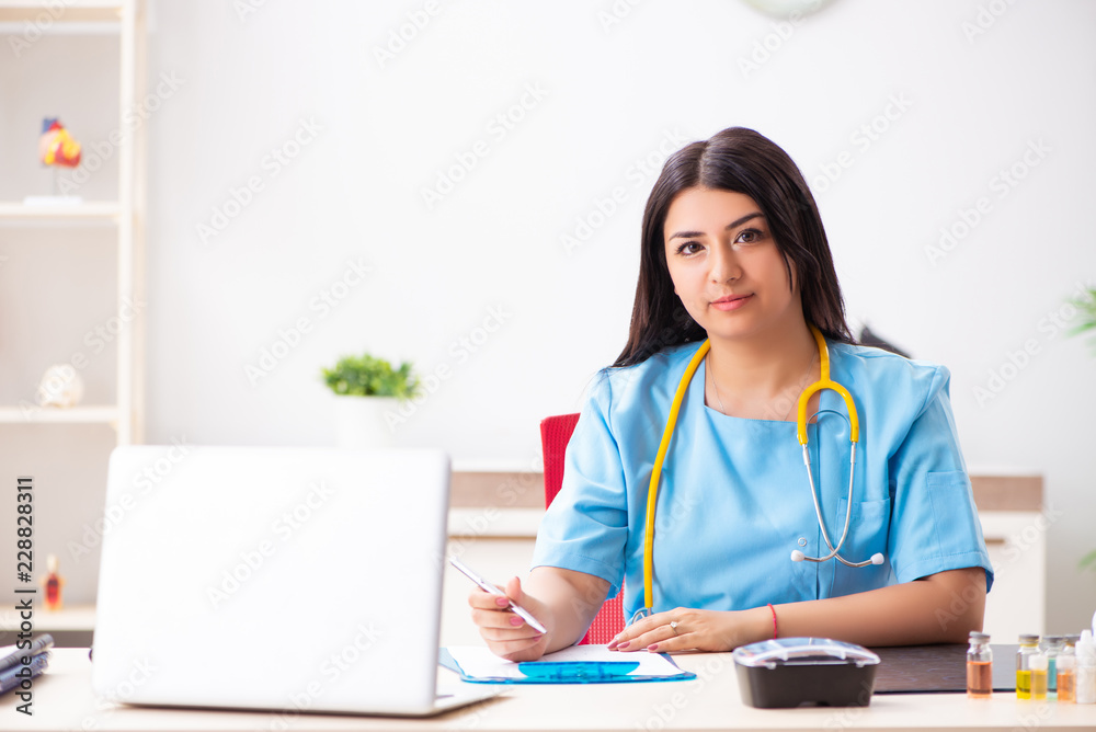 Young beautiful female doctor working in the clinic Young beautiful female doctor working in the clinic