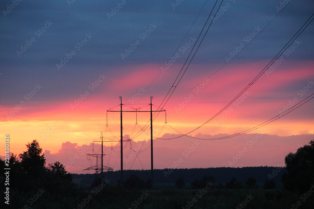 Sunset with crimson clouds and high-voltage line