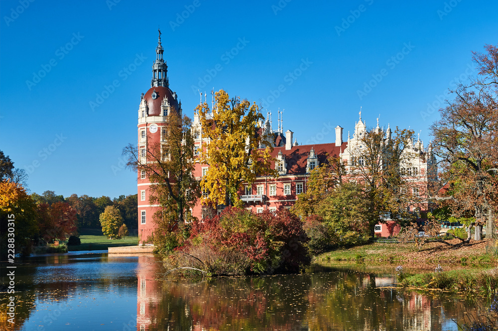 New Castle and pond in the park Muskauer  during autumn in Germany.