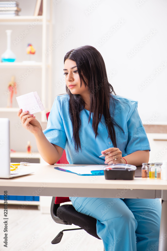 Young beautiful female doctor working in the clinic 