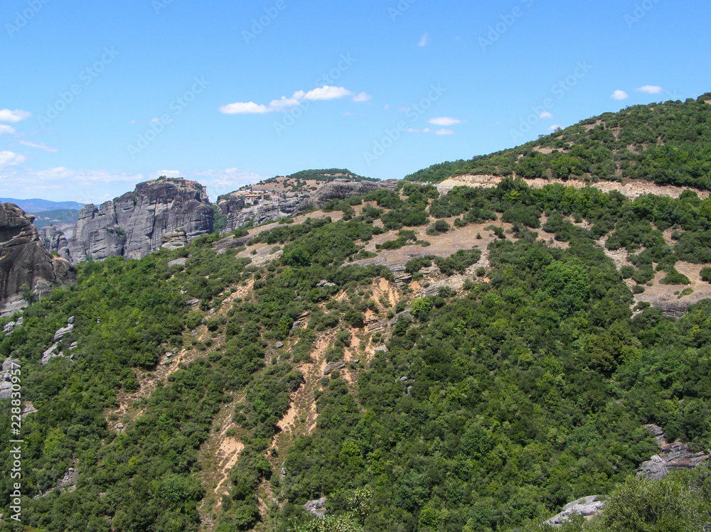 Colorful natural European landscape. Mountain range with green trees.