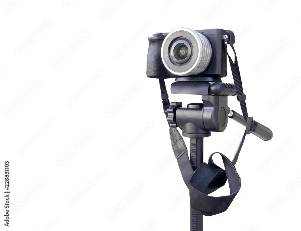 Digital camera on the tripod isolated over white