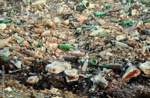 Large garbage dump waste with broken bottles